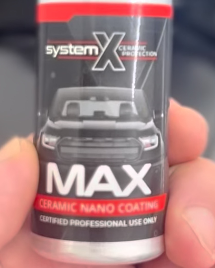 Close-up of a System X MAX ceramic nano coating bottle label reading certified professional use only
