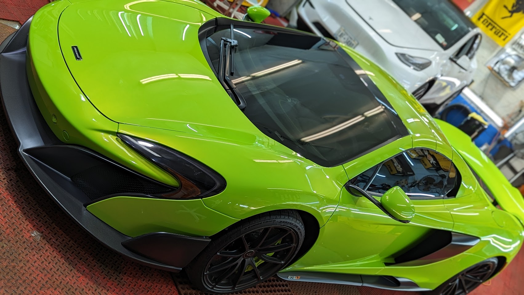 Exotic cars being detailed inside the Flawless Detail shop