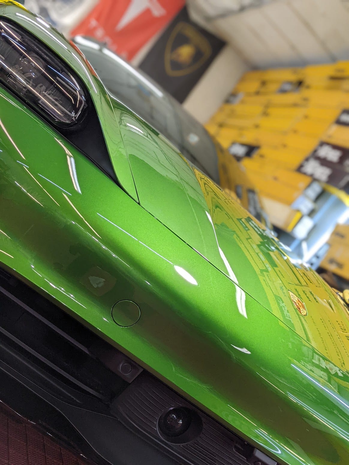 Freshly detailed green Porsche inside the Flawless Detail shop in Dallas
