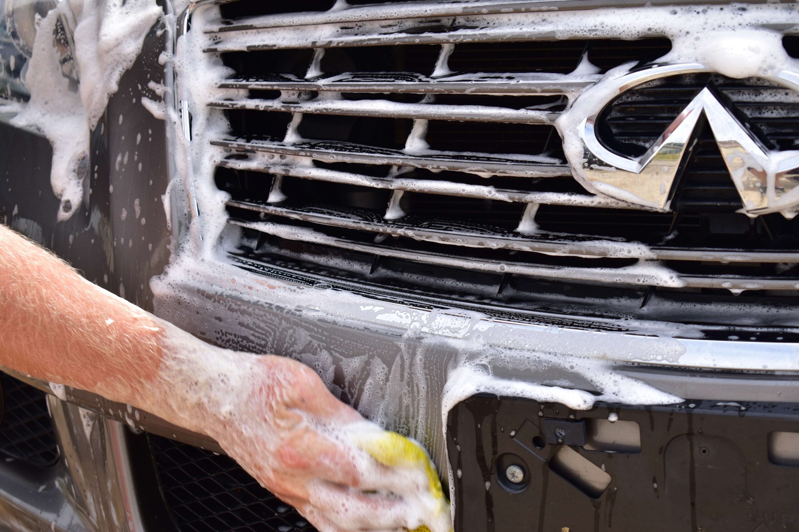 Hand-washing a vehicle's front grille